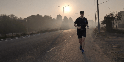 Almost silhouette of a runner on a lonely road